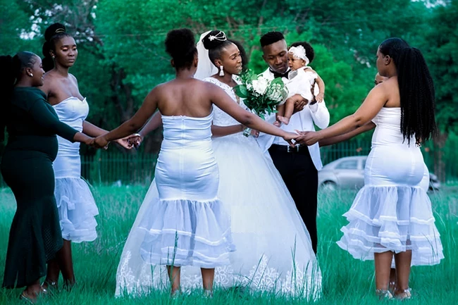 Bride and groom strolling hand-in-hand outdoors during wedding photoshoot